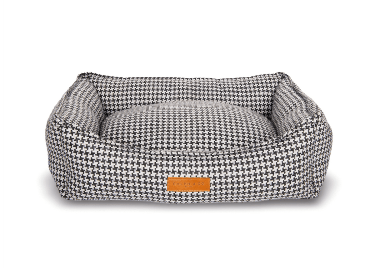 Ralph & Co Kensington luxury houndstooth bolster nest dog bed with plush cushioning and supportive raised edges.