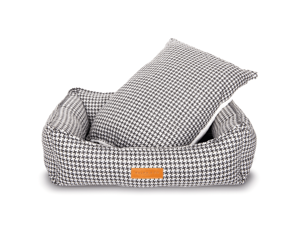Luxury Ralph & Co Kensington houndstooth bolster nest dog bed with plush padding and supportive sides for cozy comfort.